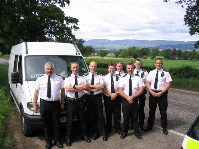 Automatic Number Plate Recognition deployment for G8 Summit 4th – 9th July 2005, A822, Muthill, Scotland. Left to right: Mike Addis,Mick Morris, Kevin Roseblade, Andy Baker, Baz Williams, Bill Jenkins, Paul Thomas, Tony Wallace. (Gloucestershire Police Archives URN 2252)