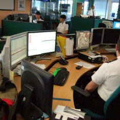 Force control Room 2010 Inspector Simon Todd standing Operator on Far left Kirsty Lewis. (Gloucestershire Police Archives URN 2637)