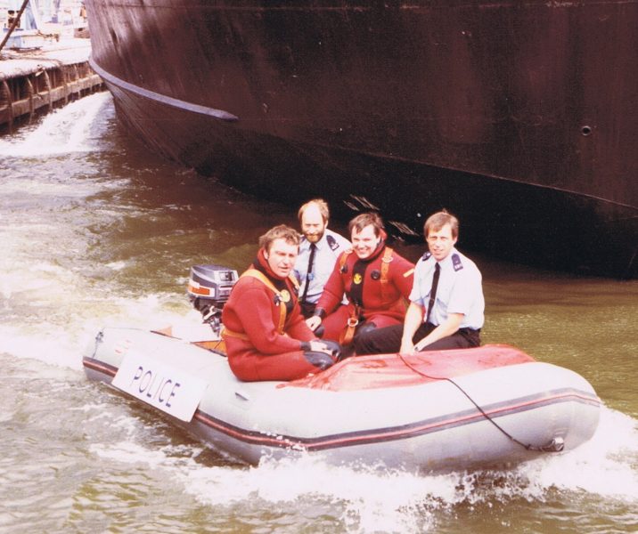 Underwater Section Sharpness Docks. Roger Sandall in rear of boat, Mark Westgate on left Nick Jefferies in middle and Ian Robinson on the right. Two officers in uniform are not wearing life jackets. (Gloucestershire Police Archives URN 7872) | Photograph from Colin Manton