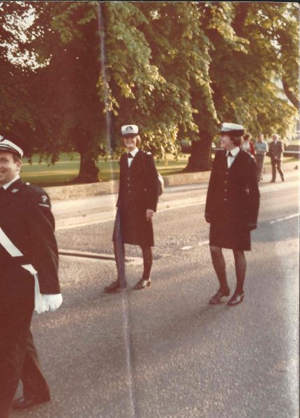 Woman Police Constables Debbie Croome and Sue Nield in 1979 escorting St John's Ambulance during a parade through Cheltenham both carrying issue handbags. (Gloucestershire Police Archives URN 10910)