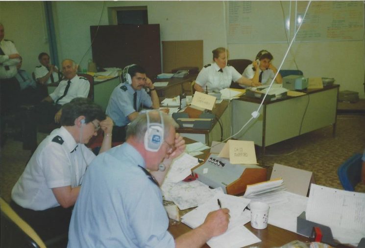 Royal International Air Tattoo 1991 Control Room. Police Constable Dick Godwin in foreground with Control Room operator Irene Gobbin. Control Room Operator Mike Stroud in centre of picture with Operators Liz Forbes and Linda Marks to right of picture. (Gloucestershire Police Archives URN 6043) | Photograph from Wayne Freeth-Selway